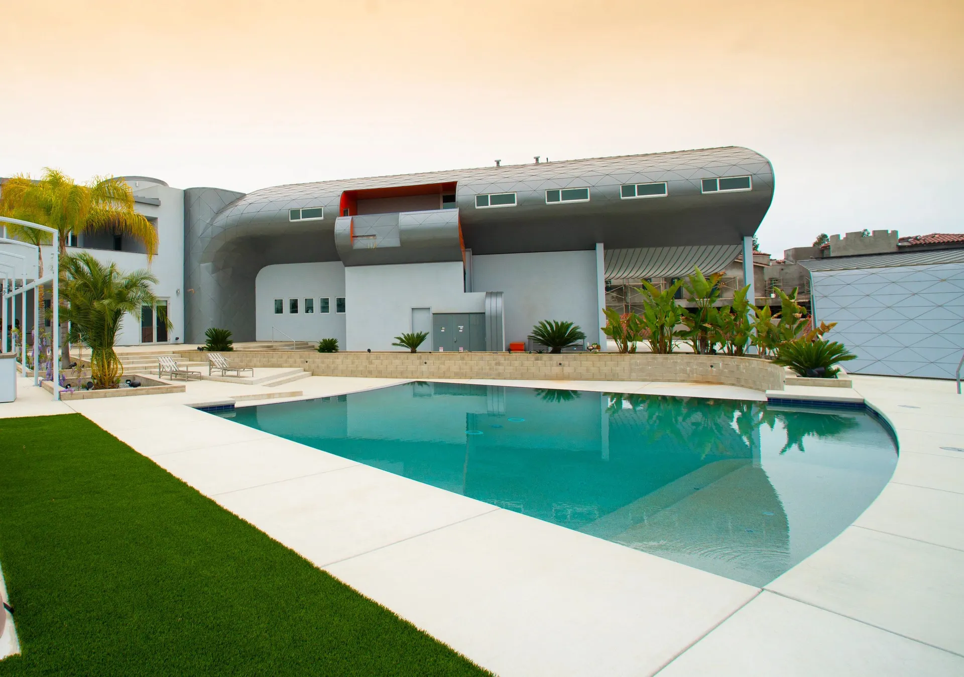 A pool house extends the architecture outdoors beneath the Central Valley sun.
