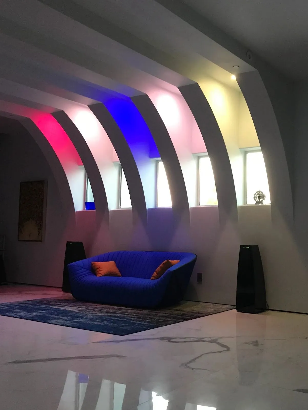 A design study explores a precise building mass with a bright orange accent.